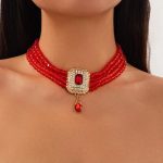 Oriental beaded rhinestone choker necklace with gold-tone pendant