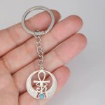 Llavero Ankh dorado con ala y piedra turquesa